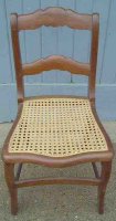 Traditional hole caning woven through holes in framework.