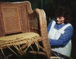 Cathryn Peters repairing paper fibre rush wicker rocker