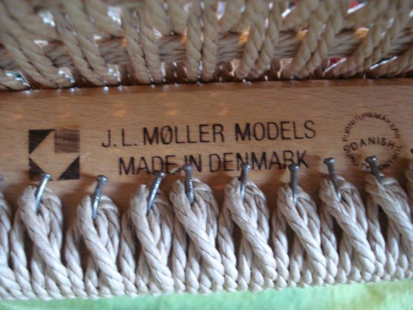 J.L. Moller Danish manufacturer's stamped logo on chair rail. 