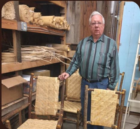 Man in front of wicker chairs and supplies