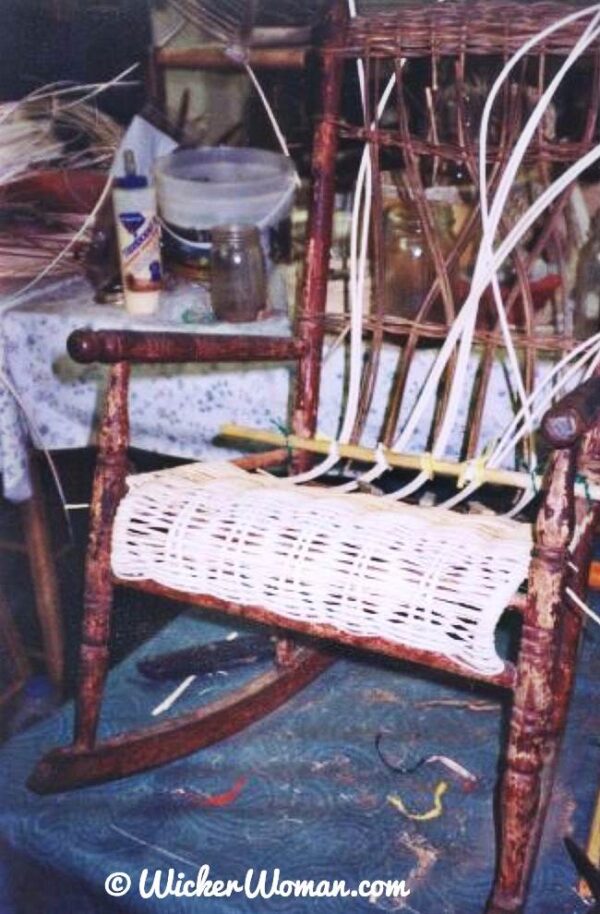 I'm in the process of weaving the seat and back of this 1920s child's wicker rocker. 