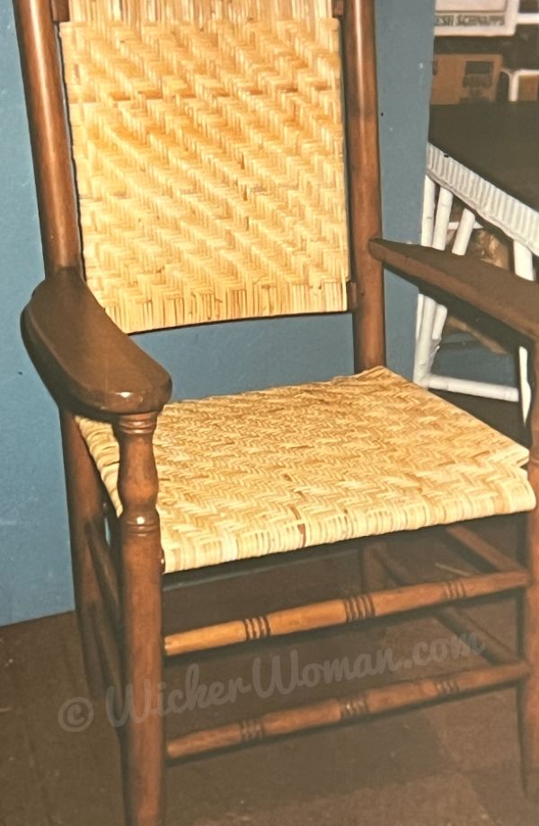 Wide binding cane arm chair with both seat and back woven in 4x4 twill pattern.